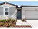 Charming single-Gathering home featuring an inviting entrance and an attached garage at 1340 Oak Valley Drive, Auburndale, FL 33823