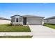 Charming single-Gathering home with a well-manicured lawn and a two-car garage at 1340 Oak Valley Drive, Auburndale, FL 33823