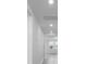 Bright hallway featuring fresh, white paint and recessed lighting at 1340 Oak Valley Drive, Auburndale, FL 33823