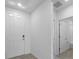 Hallway featuring neutral colors and tile flooring with views of the entryway and bathroom at 1340 Oak Valley Drive, Auburndale, FL 33823