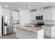 Bright kitchen featuring stainless steel appliances, granite countertops, and ample storage space at 1340 Oak Valley Drive, Auburndale, FL 33823