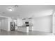 Open-concept living room and kitchen area with stainless steel appliances and an island at 1340 Oak Valley Drive, Auburndale, FL 33823