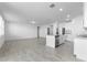 Spacious living room featuring tile flooring flowing into a kitchen with stainless steel appliances at 1340 Oak Valley Drive, Auburndale, FL 33823