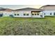 Home backyard view of a modest lawn, patio, and exterior windows at 1397 Axel Cir, Winter Haven, FL 33880