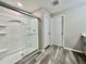 Bathroom with a glass-enclosed shower, tile floor, and white door at 1397 Axel Cir, Winter Haven, FL 33880