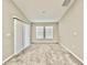 Neutral bedroom with carpet, two windows, and sliding glass door for natural light at 1397 Axel Cir, Winter Haven, FL 33880