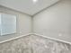 Neutral bedroom with carpet, window with blinds, and base trim at 1397 Axel Cir, Winter Haven, FL 33880