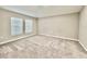 Neutral bedroom featuring carpet and two windows with blinds at 1397 Axel Cir, Winter Haven, FL 33880