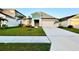 Inviting single-Gathering home with a well-kept lawn, landscaping, and a spacious driveway at 1397 Axel Cir, Winter Haven, FL 33880