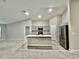 Open-concept kitchen with an island, stainless steel appliances, gray cabinets, and modern finishes at 1397 Axel Cir, Winter Haven, FL 33880