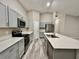 Well-equipped kitchen featuring gray cabinets, stainless steel appliances, and a central island at 1397 Axel Cir, Winter Haven, FL 33880