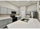 Modern kitchen with stainless steel appliances, gray cabinetry, and a spacious island with sink at 1397 Axel Cir, Winter Haven, FL 33880