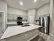 Spacious kitchen featuring gray cabinets, stainless steel appliances, and a central island with seating at 1397 Axel Cir, Winter Haven, FL 33880