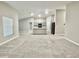Spacious open-concept living room with neutral walls and plush carpet, showcasing ample natural light at 1397 Axel Cir, Winter Haven, FL 33880