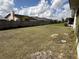 Large backyard with grass and a fence in the background at 1411 Grand Cayman Cir, Winter Haven, FL 33884
