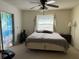 Bright bedroom with a ceiling fan, a closet, and a window with pleasant views at 1411 Grand Cayman Cir, Winter Haven, FL 33884