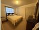 Cozy bedroom with a large bed, carpet floors, window with curtains, closet, and a dresser at 1411 Grand Cayman Cir, Winter Haven, FL 33884