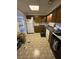 Cozy kitchen featuring appliances, a window, and tile flooring at 1411 Grand Cayman Cir, Winter Haven, FL 33884