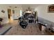 Living room with tile and carpeted floors, a drum set and view of the front door at 1411 Grand Cayman Cir, Winter Haven, FL 33884