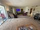 Open living room featuring carpeted floors, recliners, a cat tree, a drum set and a sliding door at 1411 Grand Cayman Cir, Winter Haven, FL 33884