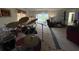 Open living room featuring carpeted floors, two recliners, a drum set and a sliding door at 1411 Grand Cayman Cir, Winter Haven, FL 33884