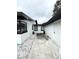 Backyard exterior view of the house with white rock and a concrete walkway at 1442 Gilmore Ave, Lakeland, FL 33805