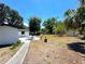 Spacious backyard with a patio, perfect for outdoor entertaining and relaxing with privacy fence at 1442 Gilmore Ave, Lakeland, FL 33805