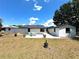 Backyard features a patio with outdoor seating, privacy fence, and plenty of green space at 1442 Gilmore Ave, Lakeland, FL 33805