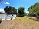 Large backyard with a patio area, partial fence, and plenty of space for outdoor activities at 1442 Gilmore Ave, Lakeland, FL 33805