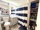 Well-lit bathroom with a stylish vanity and a shower with a striped curtain at 1442 Gilmore Ave, Lakeland, FL 33805