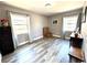 Bright bedroom with wood look floors and ample natural light from two large windows at 1442 Gilmore Ave, Lakeland, FL 33805