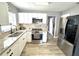 Modern kitchen featuring white cabinets, granite countertops and stainless steel appliances at 1442 Gilmore Ave, Lakeland, FL 33805