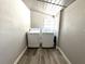 Clean laundry room with washer and dryer hookups, wood look floors, and bright natural light at 1442 Gilmore Ave, Lakeland, FL 33805