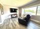 Inviting living room with a comfortable sofa, large window, and entertainment center at 1442 Gilmore Ave, Lakeland, FL 33805