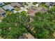 Aerial shot showcasing a home surrounded by lush greenery and mature trees in a quiet neighborhood at 1447 Kingfish Ln, Winter Haven, FL 33884