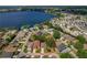 Lovely aerial view of a lakeside home in a friendly neighborhood with mature trees and a great view at 1447 Kingfish Ln, Winter Haven, FL 33884