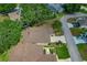 A bird's eye view of the property highlights its roof, driveway, and lush landscaping within a suburban setting at 1447 Kingfish Ln, Winter Haven, FL 33884