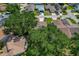 Overhead view of property showcasing large trees, roof, and driveway in a suburban neighborhood at 1447 Kingfish Ln, Winter Haven, FL 33884