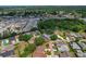 Aerial view showcasing property among dense trees in a residential area near a lake, providing privacy at 1447 Kingfish Ln, Winter Haven, FL 33884