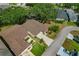 An aerial view reveals a well-maintained home with a brown roof and a driveway with two cars at 1447 Kingfish Ln, Winter Haven, FL 33884