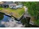 Lovely aerial view of a yard featuring a wooden deck and water access at 1447 Kingfish Ln, Winter Haven, FL 33884