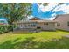 Spacious backyard with a fenced patio area, pergola, and well-maintained lawn at 1447 Kingfish Ln, Winter Haven, FL 33884