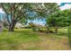Lush backyard features mature trees and landscaping, enhancing the property's appeal at 1447 Kingfish Ln, Winter Haven, FL 33884