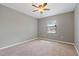 A well-lit bedroom featuring carpet and a ceiling fan at 1447 Kingfish Ln, Winter Haven, FL 33884