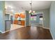 Open-concept dining area with hardwood floors seamlessly connecting the kitchen and living spaces at 1447 Kingfish Ln, Winter Haven, FL 33884