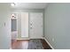 Entryway with hardwood floors, soft green walls, and a white front door creating a warm and inviting atmosphere at 1447 Kingfish Ln, Winter Haven, FL 33884