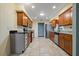 Updated kitchen features wood cabinets, stainless steel appliances, and a skylight for natural lighting at 1447 Kingfish Ln, Winter Haven, FL 33884