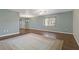 Spacious living room with hardwood floors and a neutral area rug bathed in natural light from a large window at 1447 Kingfish Ln, Winter Haven, FL 33884