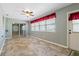 Bright living room with neutral walls, tile floor, ceiling fan, and a large window dressed with a red valance at 1447 Kingfish Ln, Winter Haven, FL 33884