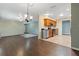 Bright, open living area featuring hardwood floors seamlessly connecting the kitchen, dining, and living room at 1447 Kingfish Ln, Winter Haven, FL 33884